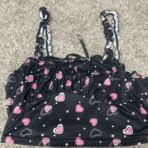 A black tank top with pink and white hearts